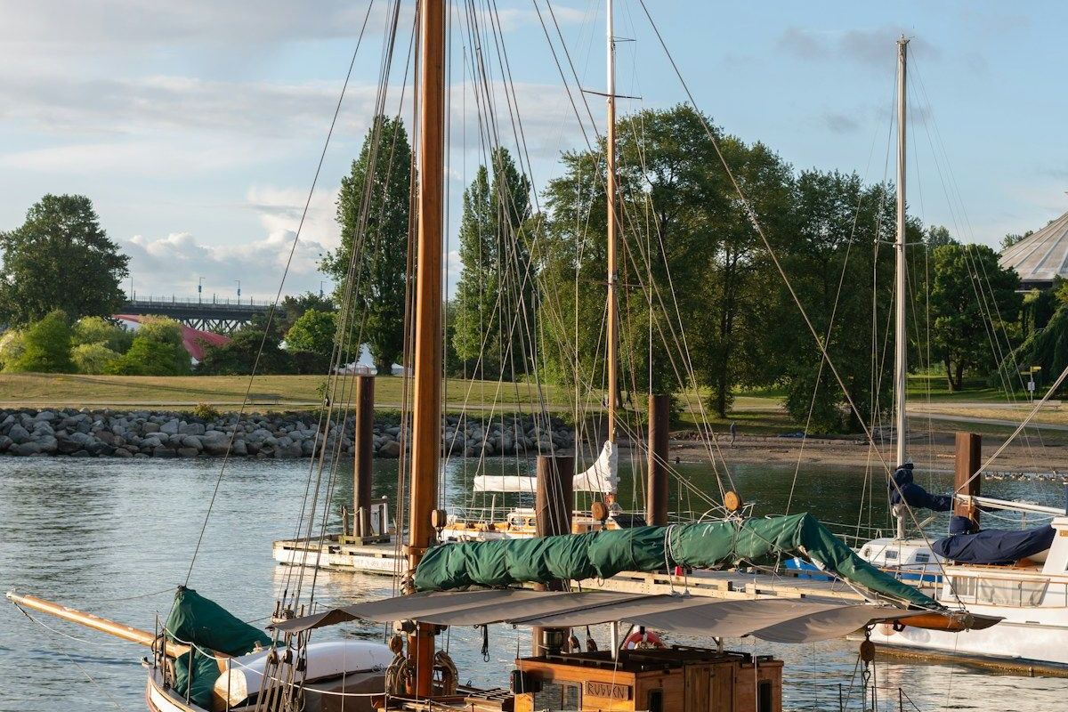 A classic wooden sailboat moored on a calm river