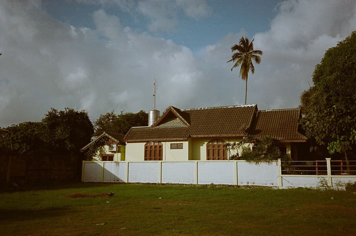 Dark storm clouds gathering over a single house and lawn